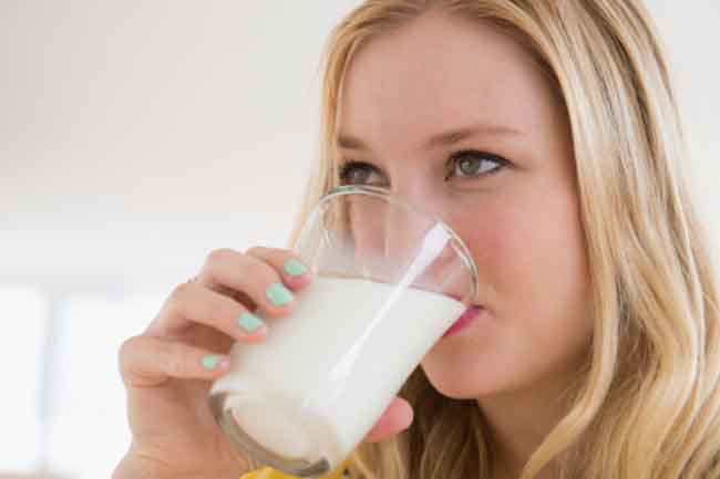 Young woman drinking milk